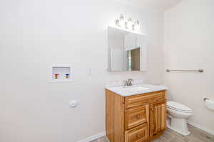Bathroom with vanity, wood finished floors, and crown molding