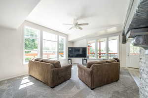 Living area featuring a ceiling fan and baseboards