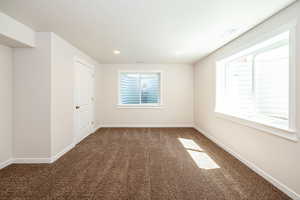 Empty room with carpet flooring and recessed lighting