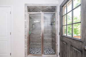 Bathroom with a stall shower and plenty of natural light