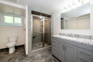 Full bath featuring vanity and a stall shower