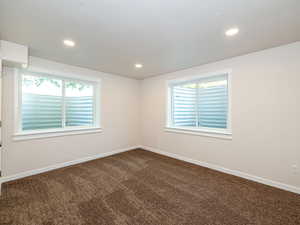 Unfurnished room featuring dark carpet and recessed lighting