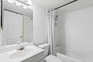 Full bath with vanity and shower / bath combination with curtain
