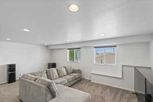 Living room with carpet flooring and recessed lighting