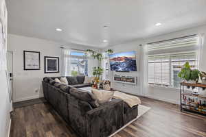 Living area with dark wood finished floors, recessed lighting, and a textured ceiling