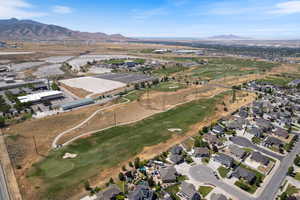 Aerial view of property's location featuring a mountain backdrop and nearby suburban area