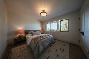 Bedroom featuring baseboards and wood finished floors