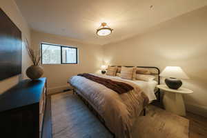 Bedroom with baseboards and wood finished floors