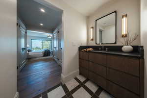 Bathroom featuring ensuite bathroom, vanity, recessed lighting, and wood finished floors