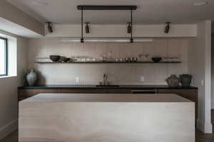 Indoor wet bar featuring baseboards