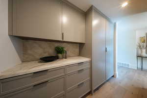 Detailed view of wood finished floors and decorative backsplash