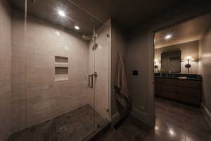 Bathroom with a stall shower, tile patterned flooring, recessed lighting, and vanity