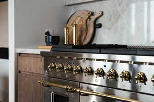 Kitchen view of stainless steel gas range oven