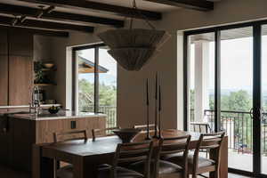 Dining area with beamed ceiling