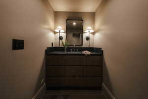 Bathroom featuring tile patterned floors and vanity