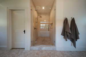 Bathroom with a stall shower and baseboards