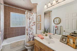 Full bath with vanity and shower / bath combo