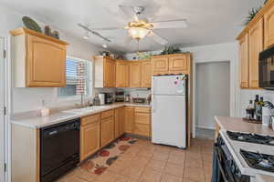 Kitchen featuring black appliances, light brown cabinets, a ceiling fan, and light countertops