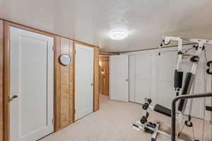 Exercise area featuring a textured ceiling