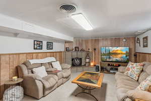 Living room with wooden walls and a wainscoted wall