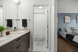 Full bathroom with double vanity, connected bathroom, and a shower with shower curtain