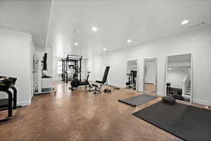 Exercise room with recessed lighting and baseboards