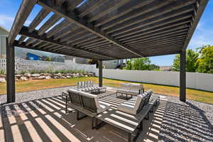 Fenced backyard with an outdoor hangout area, a patio, and a pergola