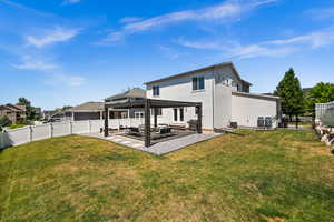 Back of property with a pergola, a fenced backyard, a patio area, stucco siding, and an outdoor hangout area