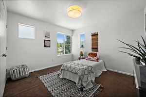 Bedroom featuring carpet floors and baseboards