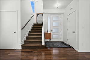 Foyer featuring wood finished floors and stairs