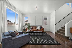 Living area with stairs and wood finished floors