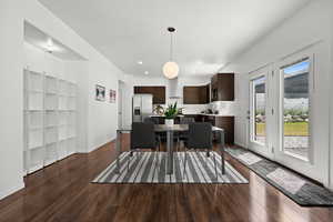 Dining space with dark wood-type flooring and recessed lighting