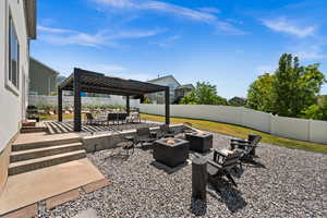 Fenced backyard featuring an outdoor living space with a fire pit, a patio, and a pergola