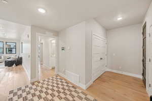Foyer featuring light wood-style floors and baseboards