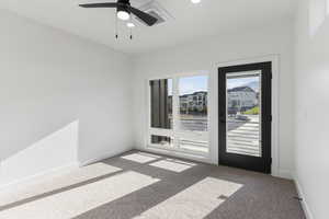 Empty room with carpet, ceiling fan, and baseboards
