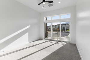 Carpeted spare room featuring ceiling fan, baseboards, and recessed lighting