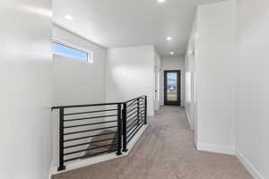 Hall featuring an upstairs landing, carpet flooring, recessed lighting, and baseboards