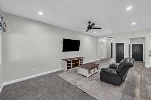 Living room with a ceiling fan, recessed lighting, and wood finished floors