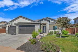 Ranch-style house featuring concrete driveway, an attached garage, brick siding, and stucco siding