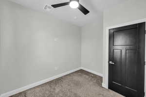 Unfurnished bedroom featuring carpet floors and ceiling fan