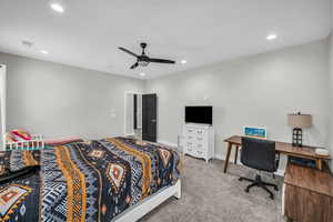 Carpeted bedroom with recessed lighting and a ceiling fan