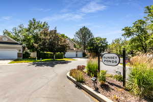 Sunset Ponds community sign featuring a garage and driveway