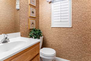 Half bathroom with vanity and toilet