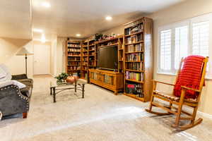 Basement sitting room featuring carpet and recessed lighting