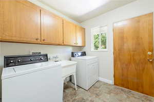 Main floor laundry  with cabinet space and washer and dryer