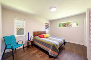 Bedroom with dark wood-type flooring