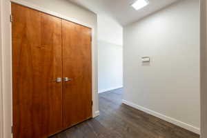 Hallway featuring dark wood finished floors.