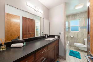 Full bathroom with vanity and washtub / shower combination with heated floors.