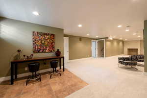 Interior space featuring recessed lighting, new carpet flooring, and stairs