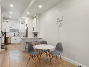 Dining space featuring recessed lighting and light wood-style flooring